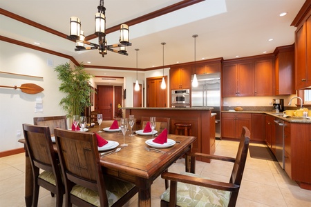 - Dining area with wooden table set for six and stylish chandelier overhead   - Open view into the kitchen with warm wood cabinetry and modern appliances   - Perfect for family dinners or hosting friends in a welcoming space