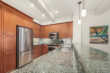 Your fully-equipped kitchen features granite countertops, stainless steel appliances, and warm wood cabinetry - perfect for preparing memorable meals during your stay.