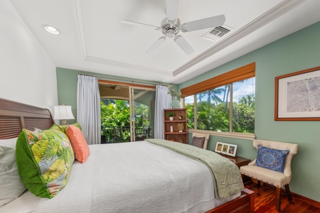 - King bedroom with tropical themed pillows and fresh, airy ambiance - Balcony and windows frame beautiful garden and palm tree views - Comfortable seating and open shelving add style and function