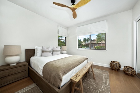 Drift into peaceful sleep in your stylish bedroom, where modern comfort meets warm wood tones and gentle breezes from the ceiling fan.