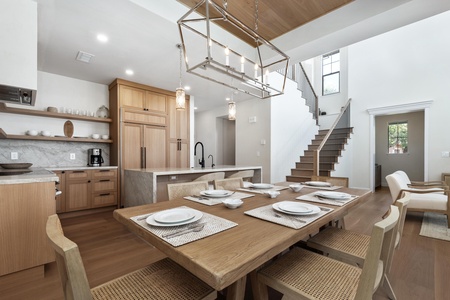 Your open-concept kitchen and dining area blends modern elegance with warm wood finishes, perfect for memorable meals together.