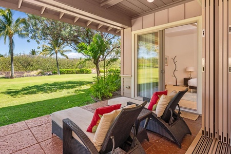 - Relax on the shaded lanai with two cushioned loungers facing beautiful greenery - Swaying palms and an stylish lawn offer a peaceful tropical escape - Sliding glass doors connect the indoor bedroom to the breezy patio
