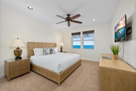 Wake up to stunning ocean views from your comfortable bed, with crisp linens and coastal breezes from your ceiling fan.
