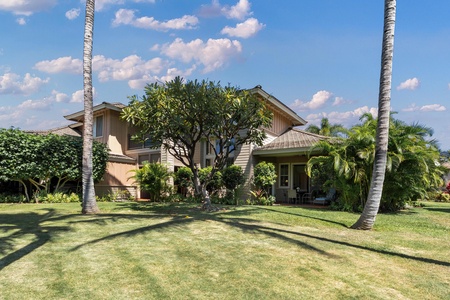Tropical paradise awaits at this stunning Hawaiian-style home, surrounded by swaying palms and manicured gardens under endless blue skies.