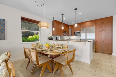 Your fully equipped kitchen and dining space invites memorable meals with warm wood tones and modern appliances.
