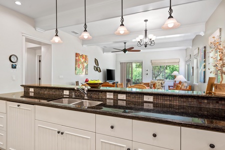 Full kitchen with breakfast bar, granite counters, and modern appliances