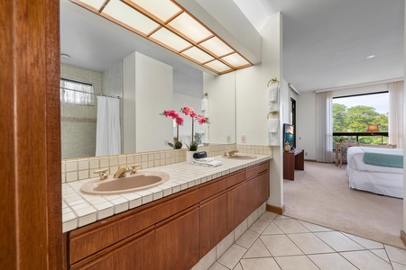 Your spacious ensuite bathroom features elegant tile work, dual vanities, and a skylight that bathes the space in natural light.
