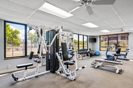Your fully equipped fitness center features modern cardio and strength training equipment with tropical views to energize your workout routine.