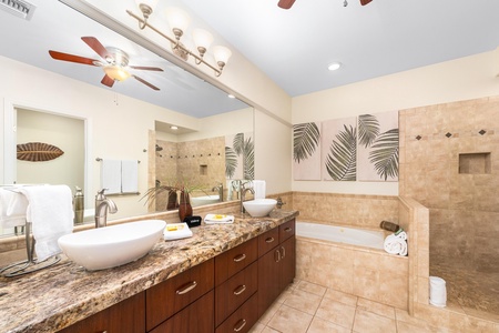 Primary bathroom with double vanity, walk-in shower, and soaking tub