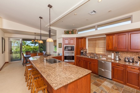 - Elegant kitchen with granite countertops and warm wood finishes   - Double ovens, large sink, and stainless steel fridge for easy cooking   - Stylish island with seating invites casual meals and social moments