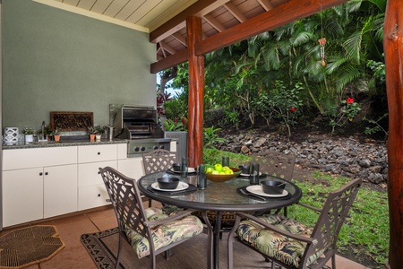 - Covered outdoor kitchen and dining area with round glass top table for four - Built in grill, sink, and counter space make alfresco cooking a breeze - Surrounded by greenery for a private, tropical dining experience