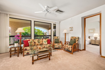 Relax in your tropical living room with bamboo furniture and garden views through sliding doors.
