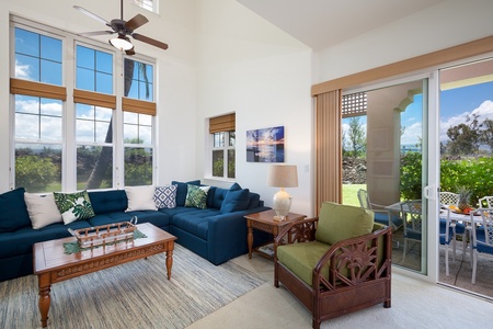 - Bright and breezy living room with a bold blue sectional and island inspired accent chair - Sliding glass doors lead straight to the lanai and beautiful garden views - Thoughtful décor and natural textures create a tranquil retreat indoors