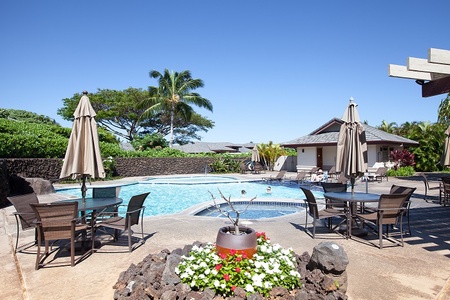 Sparkling pool with dining tables and umbrellas for relaxation.