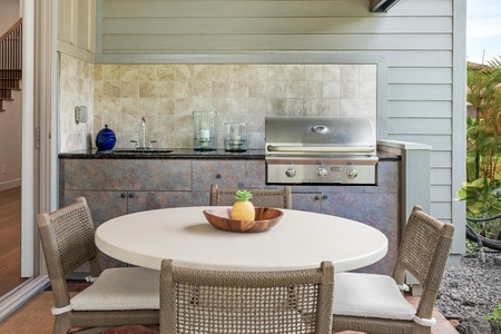 Your private outdoor kitchen awaits with granite counters, built-in grill, and tropical dining perfect for memorable meals.
