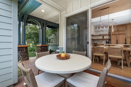 Step onto your private covered patio where tropical palms frame intimate outdoor dining, perfectly connected to your gourmet kitchen.