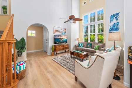 Bright, spacious living room with vaulted ceiling and tall windows