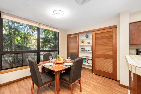 Your tropical dining space awaits with warm wood finishes and garden views through large windows.