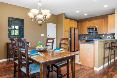 Gather around this welcoming dining space, where the open kitchen and warm lighting create a perfect setting for your meals. Everything you need to prepare and share delicious moments together.