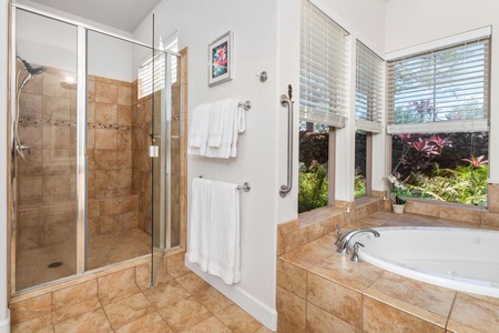 - Enjoy the style of a tiled walk in shower alongside a garden view tub - Double towel bars and sleek fixtures offer spa level comfort and style - Surrounded by large windows and natural light for a fresh airy feel