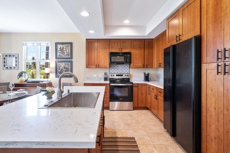 Full kitchen with breakfast bar, granite counters, and modern appliances