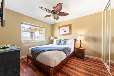 Relax in your tranquil bedroom with warm coastal touches, from the tropical ceiling fan to the cozy bed waiting for you after a day of adventure.