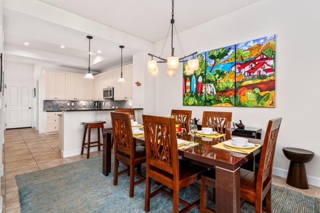 - Dine in style surrounded by bold island inspired art and vibrant decor - Open layout connects the dining area directly to the modern kitchen - Great for casual breakfasts, dinner parties, and everything between