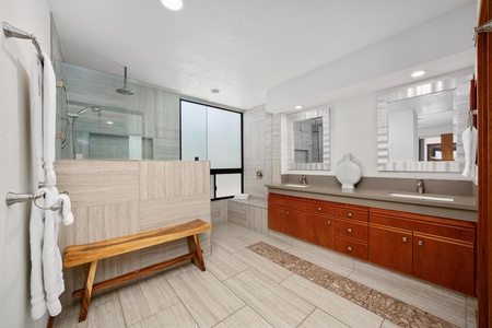 - Dual vanity bathroom with granite counters, large mirrors, and sleek tilework - Walk in rainfall shower, wooden bench, and soaking tub add comfort and functionality - Ideal setup for couples or solo travelers seeking style and ease