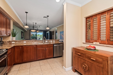 Full kitchen with breakfast bar, granite counters, and stainless steel appliances