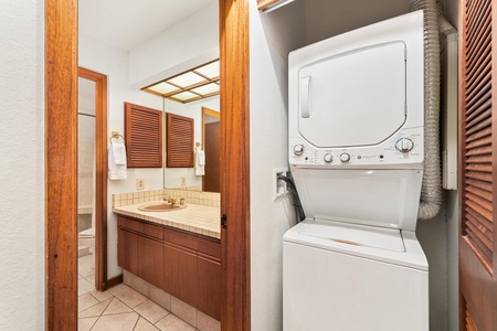 Your bathroom connects to in-unit laundry with stacked washer and dryer, making extended stays effortless with beautiful wood details throughout.