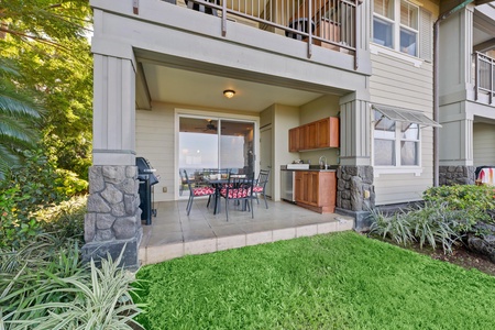 Your private patio features a full outdoor kitchen and dining area, perfect for morning coffee or evening meals surrounded by lush landscaping.