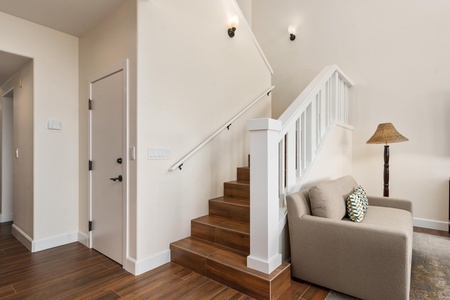 Relax in your cozy seating nook with soft lighting and warm wood tones creating the perfect reading corner.