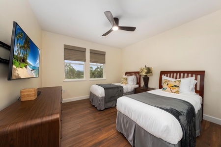 Rest comfortably in your twin bedroom with crisp linens, tropical decor, and a ceiling fan keeping you cool.