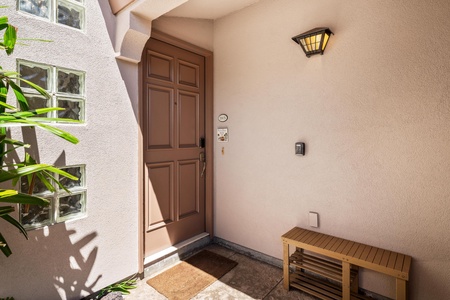 A warm and welcoming entrance with a charming wooden door and natural light filtering through the archway. Step inside to discover your comfortable getaway retreat.