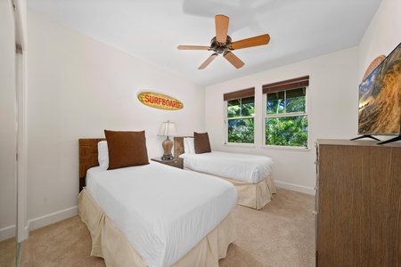 Drift off to peaceful sleep in your bright twin bedroom, where tropical touches and garden views create the perfect coastal retreat.