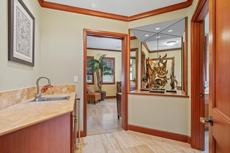 Step into your spacious suite with warm wood accents and a convenient wet bar area—perfect for mixing a morning smoothie or evening cocktail in total comfort.
