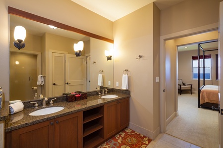 - Spacious bathroom features dual sinks, granite counters, and warm lighting - Plenty of room to get ready for beach days or dinner nights - Rich wood cabinetry and a large mirror complete the relaxed coastal vibe