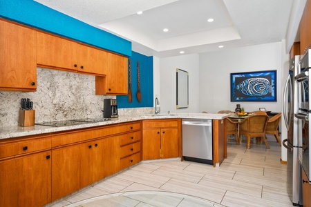 - Wraparound granite countertops and rich cabinetry offer generous space for meal prep - Built in dishwasher and coffee station make morning routines effortless - Pops of ocean blue bring a vibrant touch to this modern kitchen