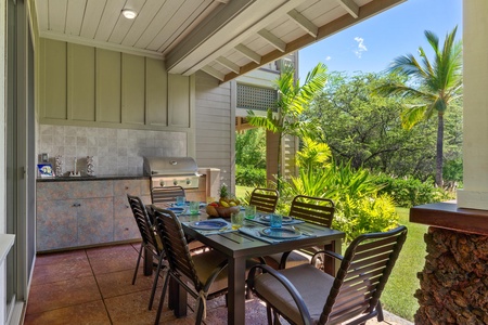 Covered lanai with garden views, dining table, and BBQ