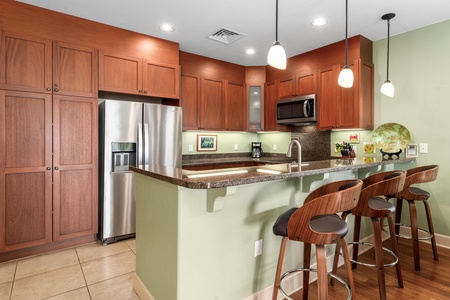 Full kitchen with breakfast bar, granite counters, and stainless steel appliances