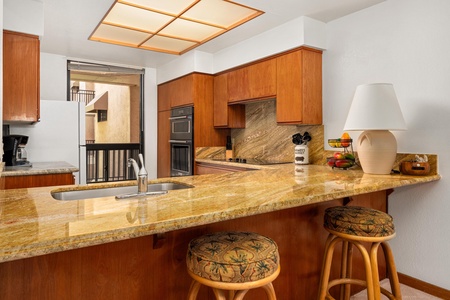 Your gourmet kitchen features warm wood cabinets, gleaming granite counters, and a perfect breakfast bar for morning coffee together.