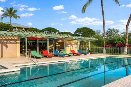 Resort style poolside with vibrant seating and a shaded pavilion.