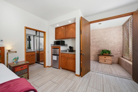 - Compact kitchenette with microwave mini fridge and coffee maker for added convenience - Smooth tile floors lead into a private stone walled patio with decorative accents - Ideal setup for morning brews or light in room snacks and drinks