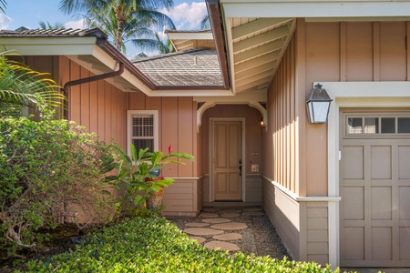 A welcoming tropical entrance surrounded by lush landscaping and swaying palms creates the perfect island getaway arrival.