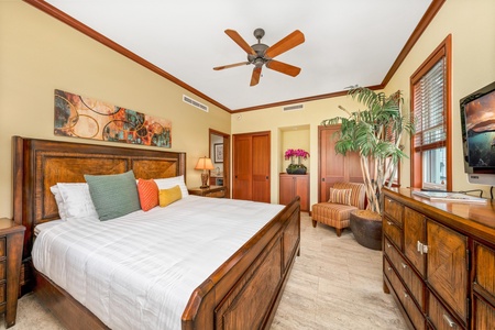 Your bedroom invites relaxation with crisp linens, warm tropical wood furnishings, and a ceiling fan for those balmy island breezes. Stylish comfort awaits after your adventures.