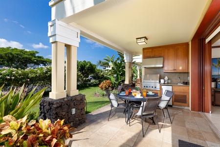 - Covered patio dining space with round table set for four and outdoor kitchen   - Built in grill, sink, and cabinetry make cooking al fresco a breeze   - Surrounded by beautiful landscaping and tropical greenery for a serene vibe