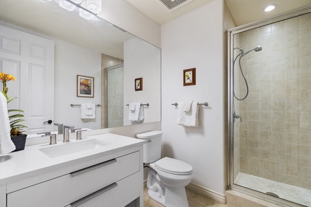 - Bathroom with sleek vanity large mirror and glass enclosed shower   - Crisp white tones create a clean fresh and modern atmosphere   - Thoughtfully designed for both style and everyday functionality