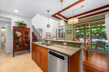 - Granite topped kitchen island with built in sink and dishwasher - Open layout connects to dining and living areas for easy entertaining - Pendant lighting and tray ceiling add a touch of elegance