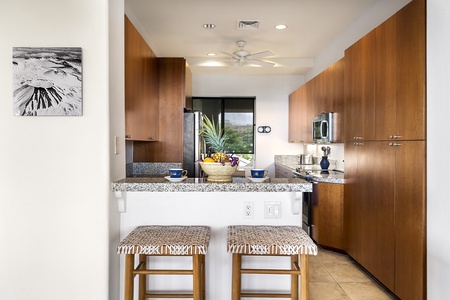 - Open kitchen with breakfast bar seating for two and granite counters   - Stainless appliances and plenty of cabinetry for all your culinary needs   - Bright and inviting space perfect for casual meals or morning coffee
