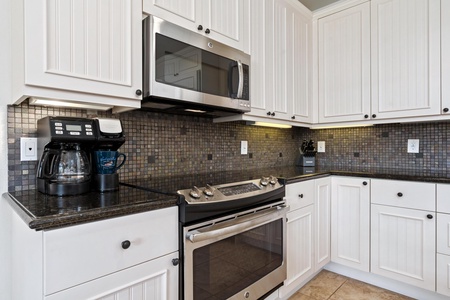 Full kitchen with breakfast bar, granite counters, and modern appliances